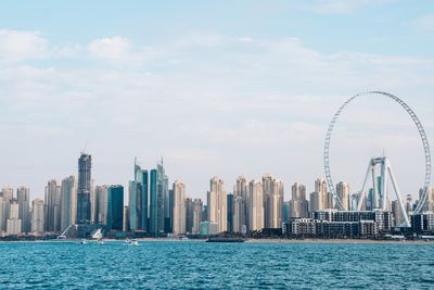 Panoramic view of sea and buildings against sky