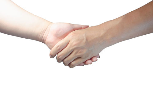 Close-up of hands over white background