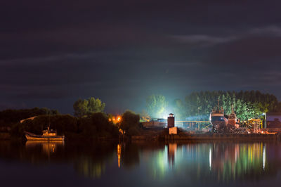 Scenic view of lake against sky at night