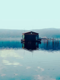 Lifeguard hut in lake against clear sky