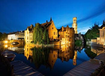 Reflection of buildings in river at night