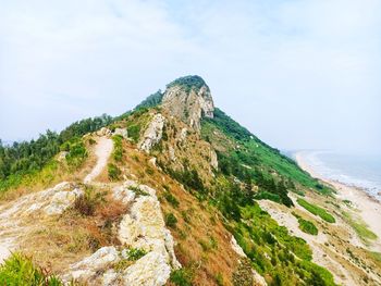 Scenic view of sea and mountains against sky