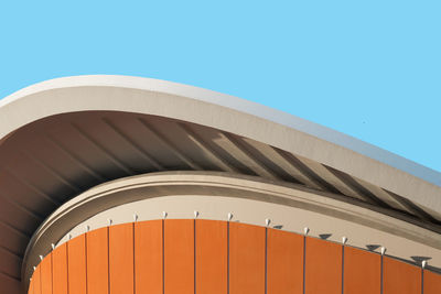 Low angle view of modern building against blue sky