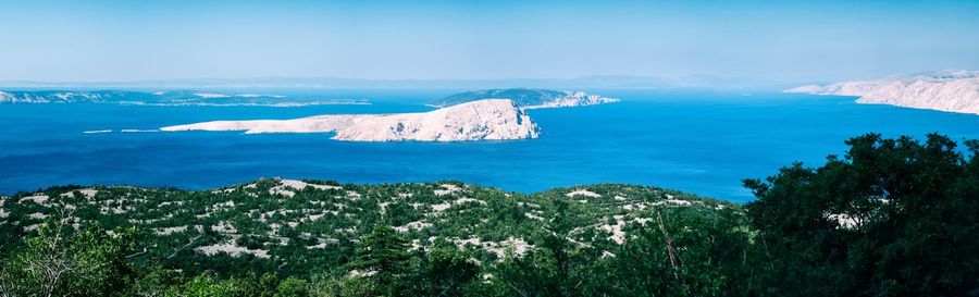 Scenic view of sea and mountains against sky