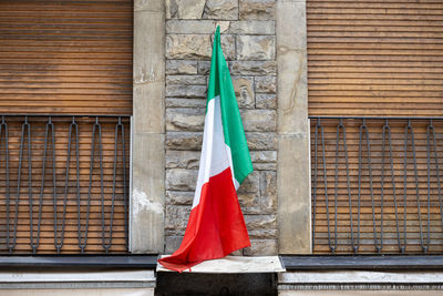 Low angle view of woman standing against brick wall