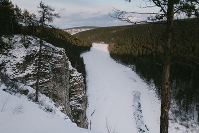 Scenic view of river against sky during winter