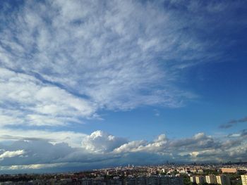 Cityscape against cloudy sky