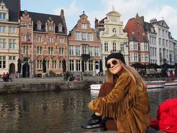 Woman with buildings in city during winter