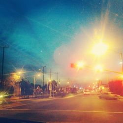Illuminated street light against sky