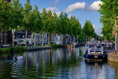 Weesp, netherlands - july 05. 2022. trees lining the herengracht canal on a summers evening