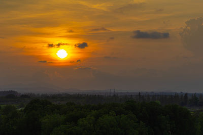 Scenic view of landscape against orange sky