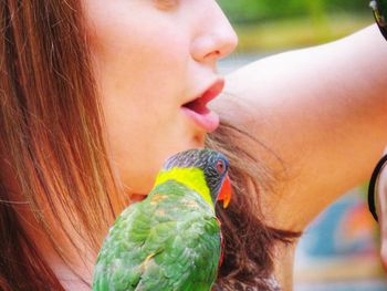 Close-up portrait of cute boy eating outdoors