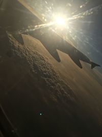 Airplane flying over sea against sky