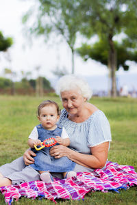 Mother and daughter sitting on plant