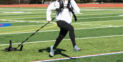Low section of man standing on field