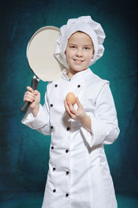 Portrait of girl standing in chef costume