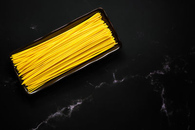 High angle view of yellow food on black background