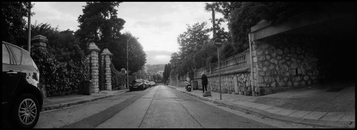 Empty road along buildings