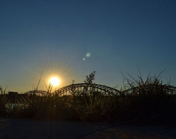 Scenic view of field against sky at sunset