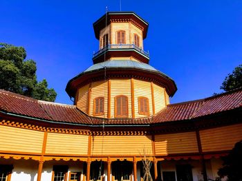 Low angle view of illuminated building against clear blue sky