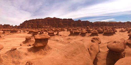 Rock formations on landscape against sky