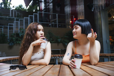 Portrait of a smiling young woman sitting outdoors