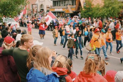 People looking at crowd in city