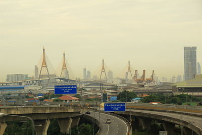 View of bridge and cityscape against sky