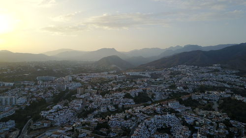 Aerial view of cityscape against sky during sunset