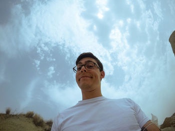 Portrait of young man against sky
