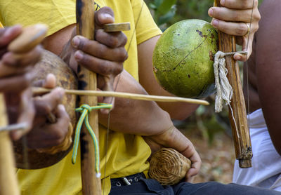 Musicians playing an instrument called berimbau during a capoeira performance in salvador, bahia