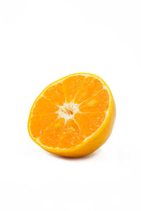 Close-up of orange slice against white background