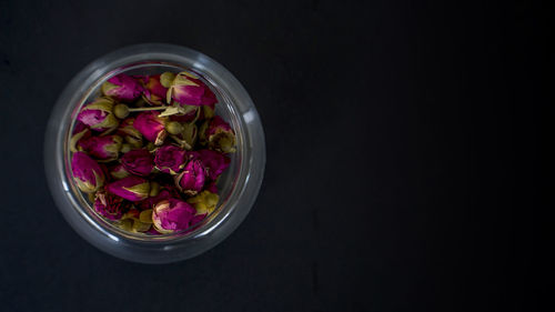 High angle view of purple flowers in bowl against black background