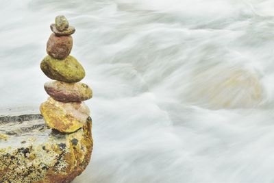 Stacked stones over river