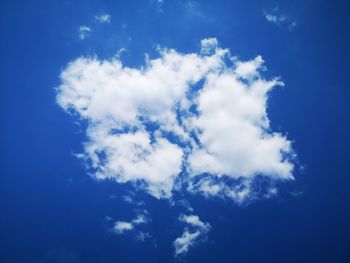 Low angle view of heart shape against blue sky