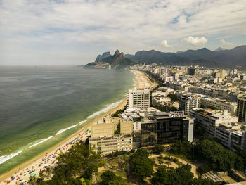 High angle view of townscape by sea against sky