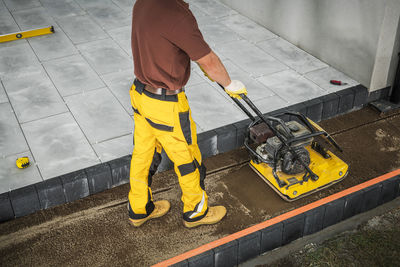 Low section of man working at construction site