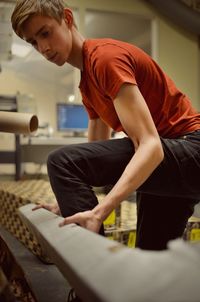 Side view of man working at workshop