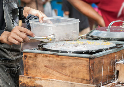 Midsection of man preparing food