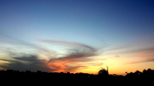 Low angle view of silhouette landscape against sunset sky