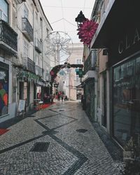 Street amidst buildings in city against sky