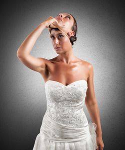 Portrait of a young woman against white background