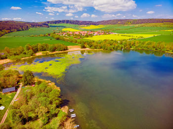 Scenic view of landscape and lake against sky