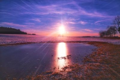 Scenic view of beach against sky during sunset