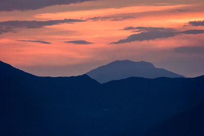 Scenic view of silhouette mountains against sky during sunset