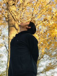 Man standing by tree during autumn