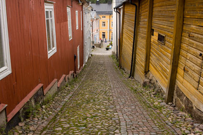 Footpath amidst buildings in city