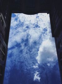 Low angle view of buildings against blue sky
