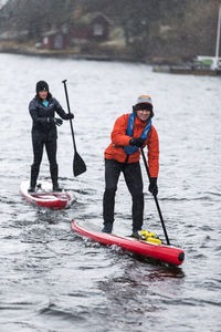 Man and woman paddle boarding