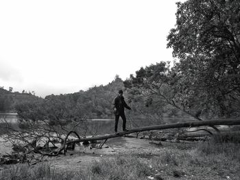 Man walking on road against sky